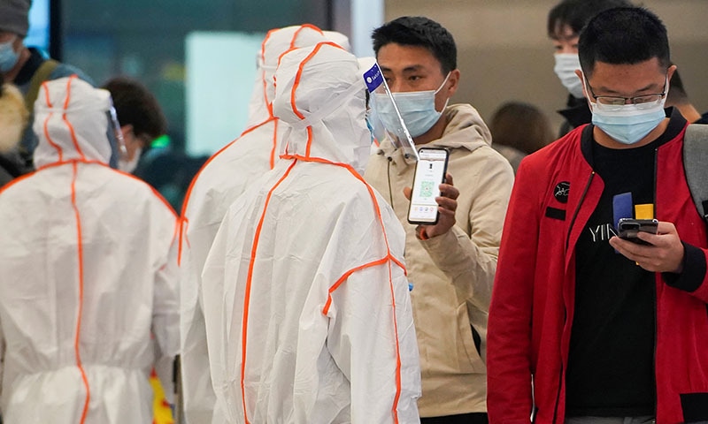 A man showing his QR code on a phone at a blocked exit at Shanghai Hongqiao Railway Station, following new cases of the coronavirus, in Shanghai, China, on Thursday. — Reuters