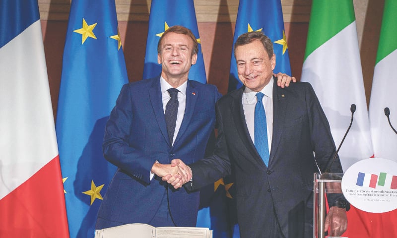 FRENCH President Emmanuel Macron (left) and Italian Prime Minister Mario Draghi shake hands during the press conference.—AFP