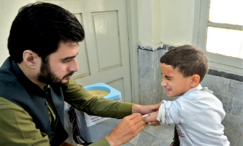 A health worker administers measles vaccine to a boy in a health centre in Gulbahar. — White Star/File