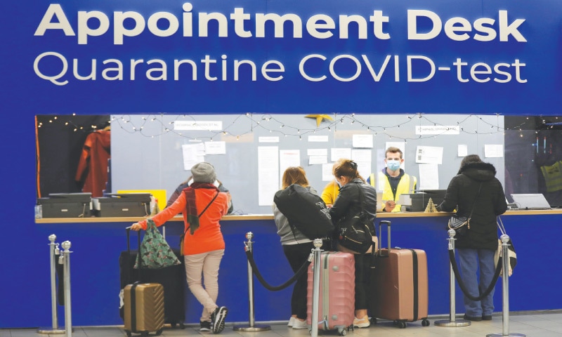 Amsterdam: People wait in front of a desk for quarantine and Covid-19 tests at Schiphol Airport on Saturday.—Reuters