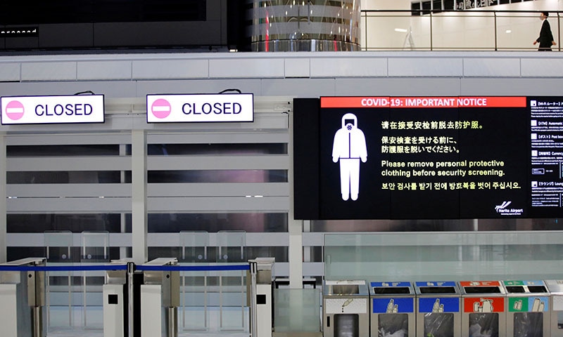A notice about Covid-19 safety measures is pictured next to closed doors at a departure hall of Narita international airport on the first day of closed borders to prevent the spread of the new coronavirus Omicron variant in Narita, east of Tokyo, Japan. — Reuters