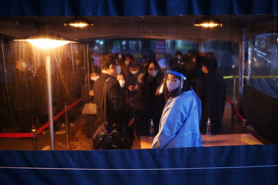 People wait in a line to undergo coronavirus test at its testing site in central Seoul, South Korea, December 1. &mdash; Reuters
