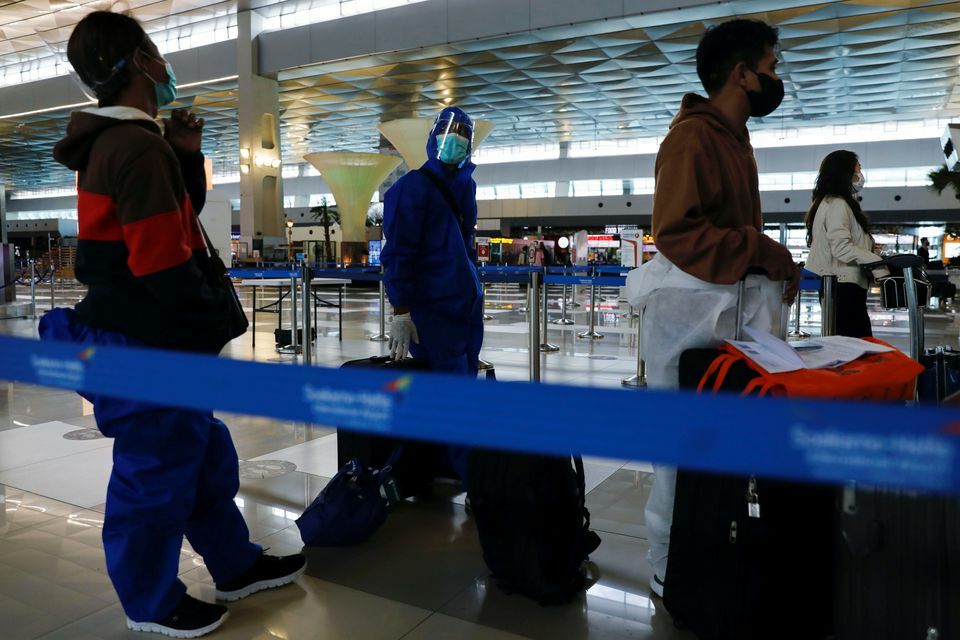 Travellers wearing protective suits are seen at the Soekarno Hatta International airport in Tangerang, near Jakarta, Indonesia, November 29. — Reuters
