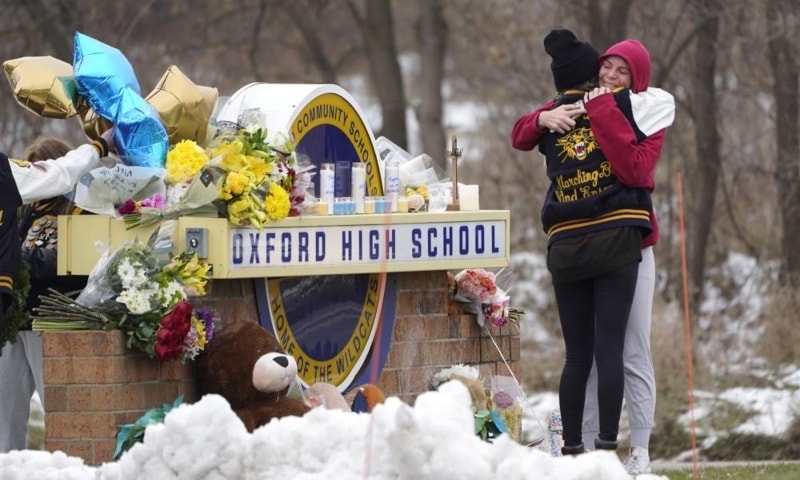 Students hug at a memorial at Oxford High School in Oxford, Michigan, US, Dec 1. &mdash; AP