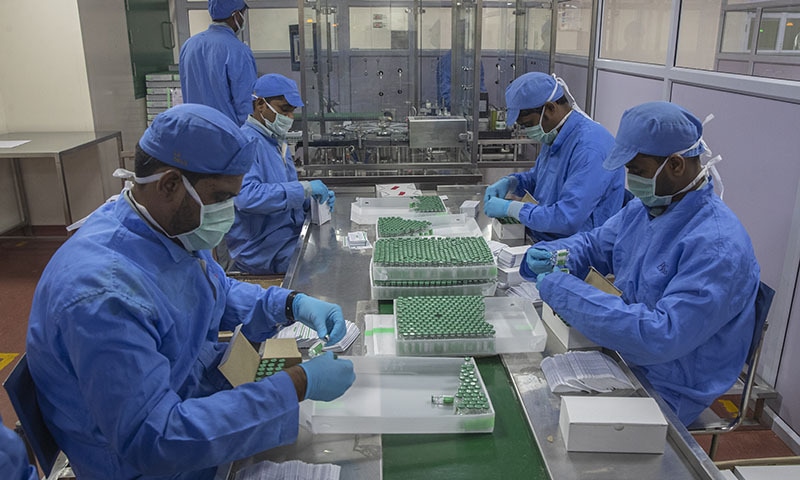 Employees pack boxes containing vials of Covishield, a version of the AstraZeneca vaccine, at the Serum Institute of India in Pune. — AP/File