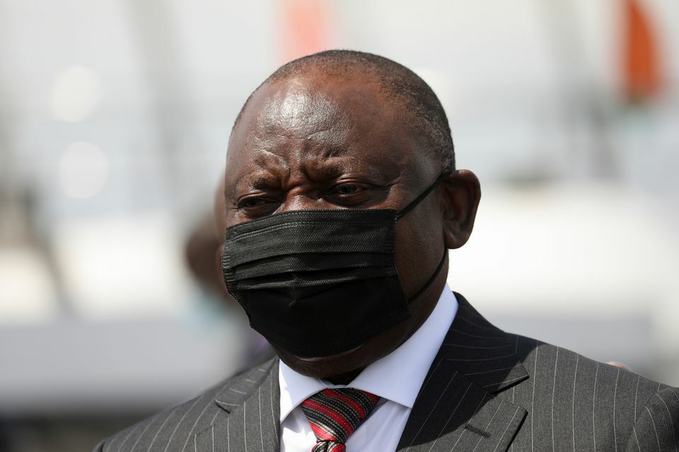 South African President Cyril Ramaphosa wears a face mask as he looks on during a visit with Ivory Coast's Prime Minister Patrick Achi at the port in Abidjan, Ivory Coast, December 3. &mdash; Reuters