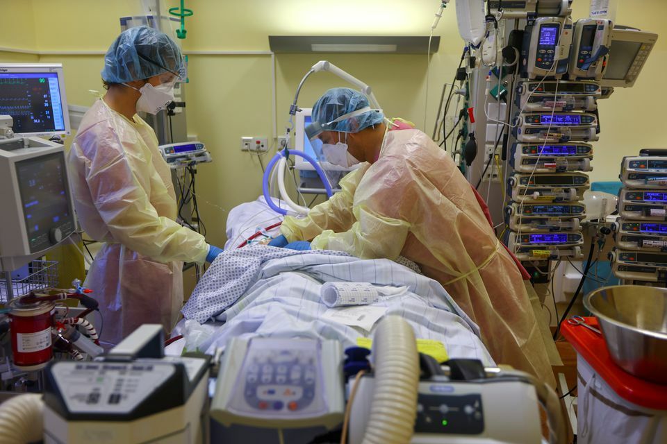 Members of the medical staff in protective suits treat a patient suffering from the coronavirus at Havelhoehe Community Hospital in Berlin, Germany, December 6. — Reuters