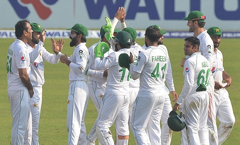 Pakistan's cricketers celebrate after the dismissal of Bangladesh's wicketkeeper Mushfiqur Rahim during the final day of the second Test match between Bangladesh and Pakistan at the Sher-e-Bangla National Cricket Stadium in Dhaka on Dec 8, 2021. — AFP