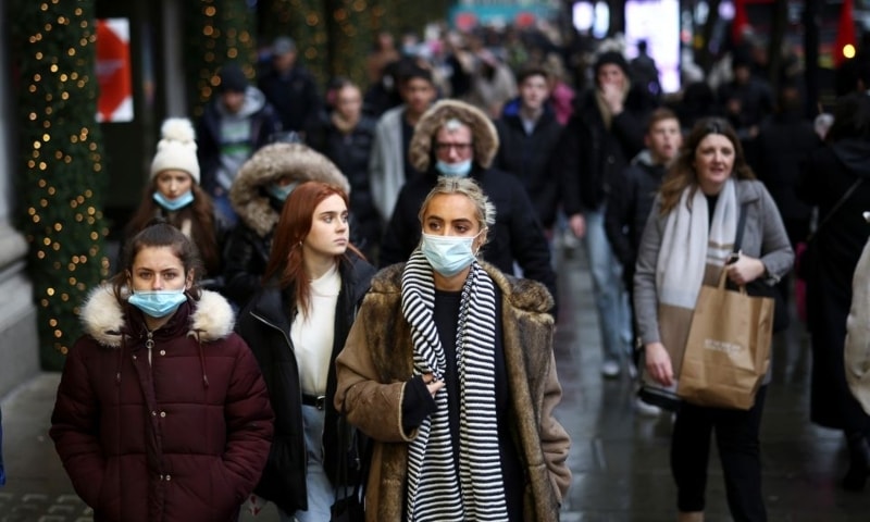People walk past a Selfridge's store on Oxford Street, amid the coronavirus outbreak in London, Britain, December 5. &mdash; Reuters