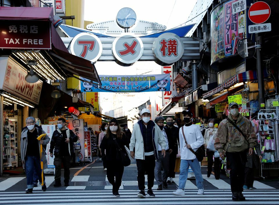 Pedestrians wearing protective masks, amid the coronavirus outbreak, make their way at the Ameyoko shopping district in Tokyo, Japan, December 1. — Reuters