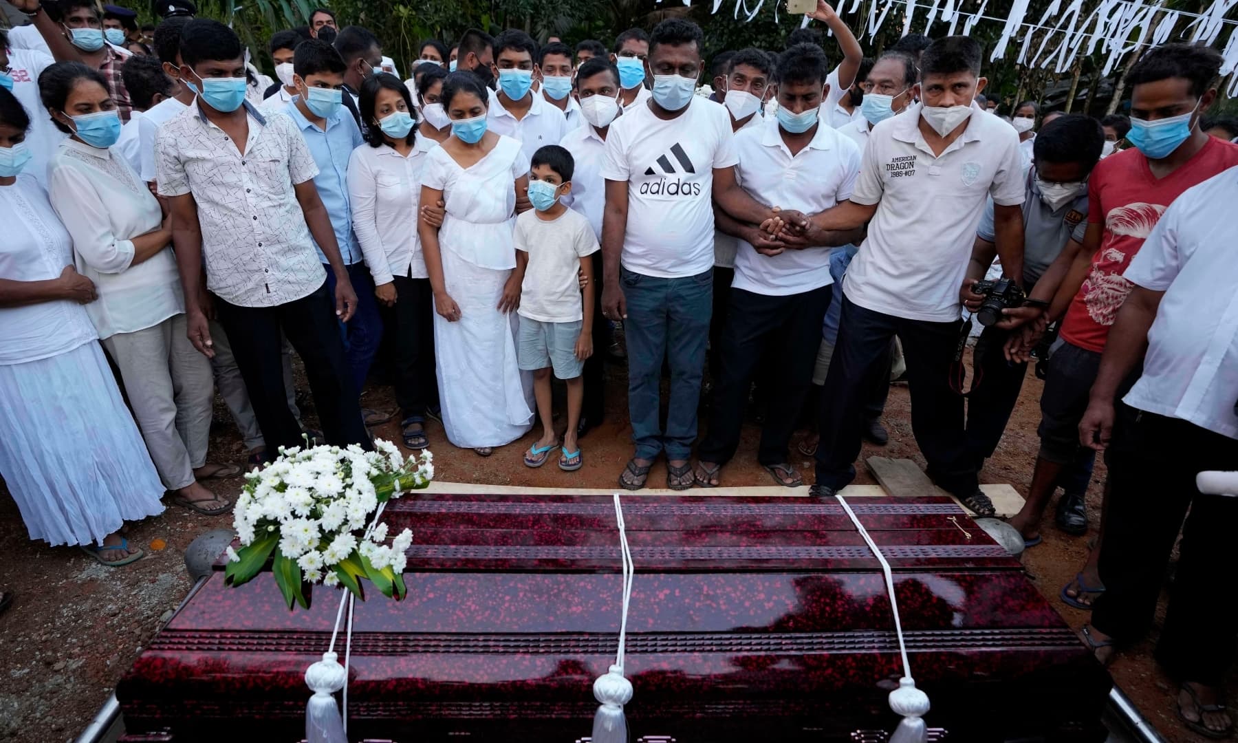 Family members of Sri Lankan factory manager Priyantha Kumara who was lynched by a mob in Sialkot for alleged blasphemy gather around the grave during his burial in Colombo, Sri Lanka on December 8, 2021. — AP