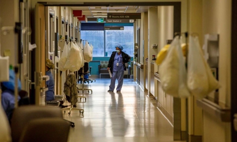 The team leader nurse gets updates from another nurse while they treat coronavirus patients inside the intensive care unit of Humber River Hospital in Toronto, Ontario on April 20. &mdash; Reuters