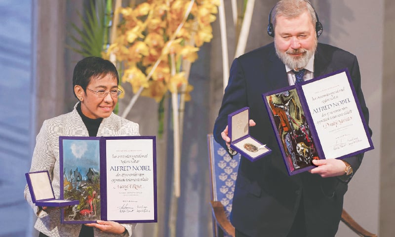 NOBEL Peace Prize laureates Maria Ressa of the Philippines (left) and Dmitry Muratov of Russia pose with the diploma and medal during the award ceremony on Friday.—AFP