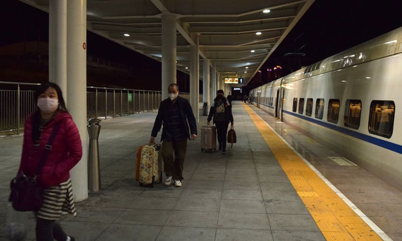 In this file photo, passengers wearing face masks get off a train at Suifenhe railway station, a city of China's Heilongjiang province on the border with Russia. — Reuters/File
