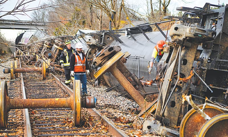 KENTUCKY: People work at the scene of a train derailment after a devastating outbreak of tornadoes ripped through several US states on Saturday. The tornadoes killed more than 70 people, leaving a trail of destroyed homes and businesses along a path that stretched more than 320 kilometres.—Reuters