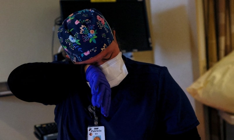 A registered nurse wipes a tear from her eye after tending to a deceased coronavirus patient in the intensive care unit at San Juan Regional Medical Centre in Farmington, New Mexico, US, December 10. — Reuters