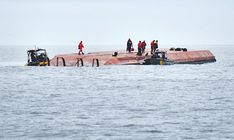 Divers work aboard a Danish cargo ship which collided with a British vessel in the Baltic Sea on Monday.
—Reuters Divers work aboard a Danish cargo ship which collided with a British vessel in the Baltic Sea on Monday.
—Reuters