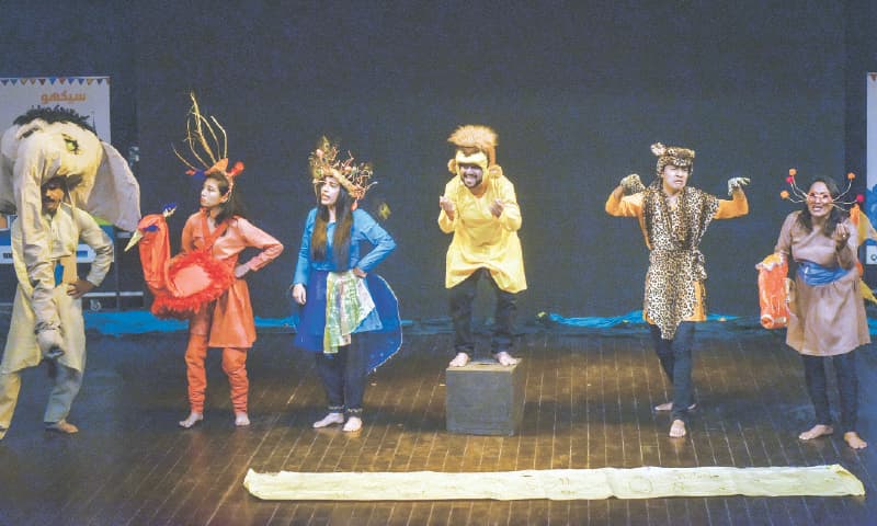 Children appear engrossed in a tale narrated by a master storyteller during the three-day Children’s Learning Festival on Tuesday while a play (right) Jungle Jungle Zindabad is also staged during the event held at the Arts Council of Pakistan, Karachi.—Fahim Siddiqi / White Star