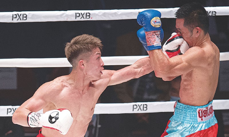 TOKYO: Japan’s Naoya Inoue (L) punches Aran Dipaen of Thailand during their WBA and IBF bantamweight title fight at the Kokugikan Arena on Tuesday.—AFP