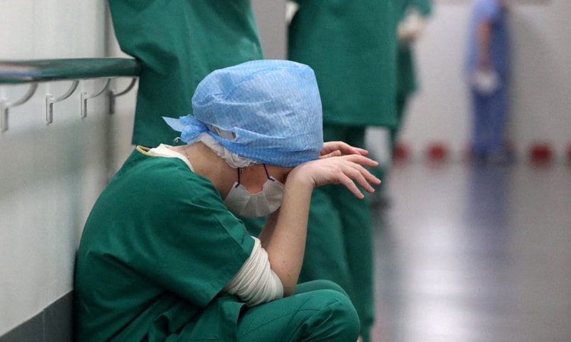 In this file photo, Doctor Ruxandra Divan rests in the intensive care unit for Covid-19 patients at Hopitaux Civils de Colmar in Colmar, France. &mdash; Reuters/File