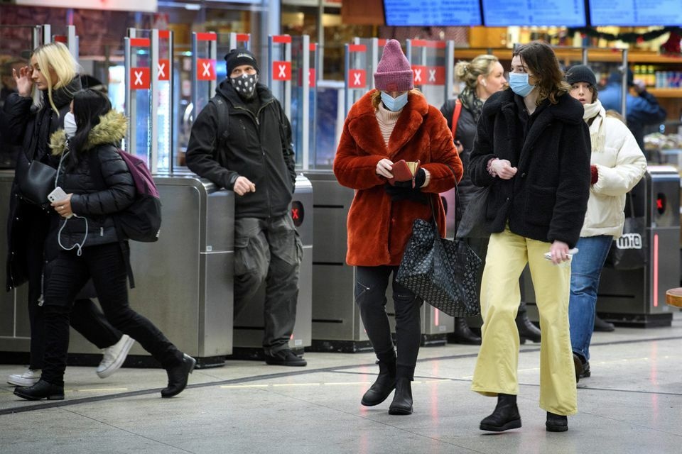 Passengers wearing protective masks enter an underground railway station, amid the spread of the coronavirus in Stockholm, Sweden on January 7. — Reuters