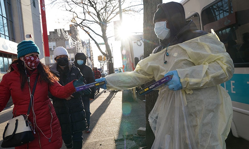 Binax Covid-19 testing kits are handed out in the Bensonhurst section of the Brooklyn borough of New York City on Thursday. — AFP