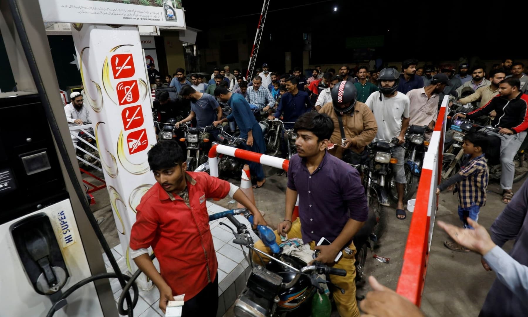 People gather to get petrol at a petrol station, after Pakistan Petroleum Dealers Association announced a countrywide strike, in Karachi on November 24, 2021. — Reuters