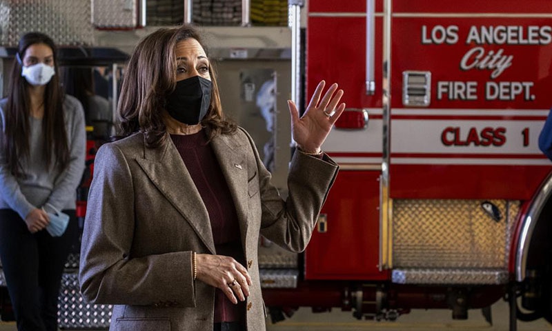US Vice President Kamala Harris, wearing a face mask speaks, with firefighters while visiting the Los Angeles Fire Department Station 94, in Los Angeles, on Friday. — AP