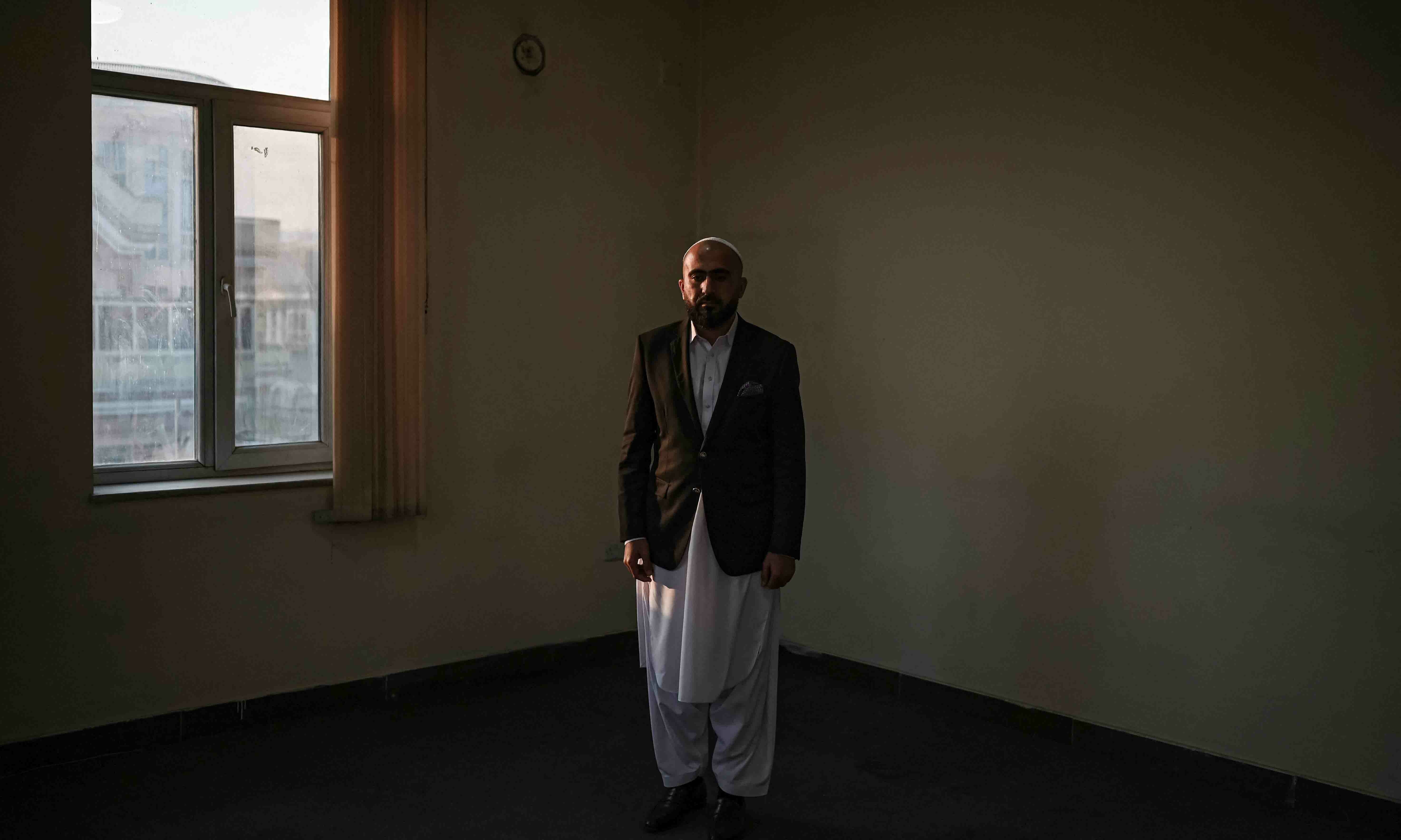 In this picture taken on December 18, Afghan businessman Shoaib Barak poses for a picture at his office in Kabul. — AFP