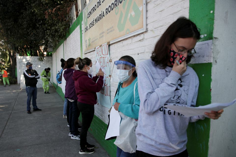 People prepare their documents before being tested for the coronavirus in Mexico City, Mexico, December 23. — Reuters