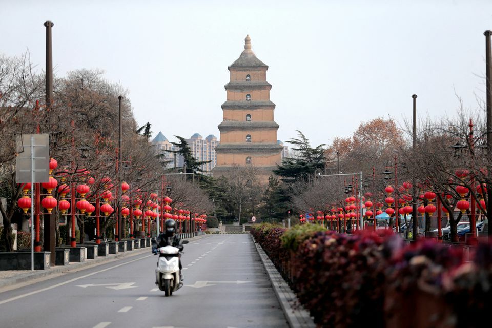 A rider travels on an empty road following lockdown measures to curb the spread of the coronavirus in Xian, Shaanxi province, China, December 26. &mdash; Reuters