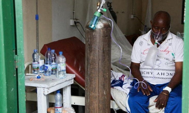 A patient breathes oxygen from an old tank at the St Joseph Covid-19 treatment centre in Kinshasa, Democratic Republic of Congo, December 24. — Reuters