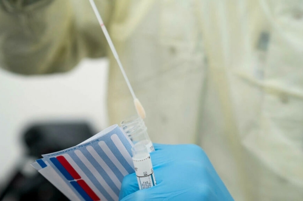 A doctor performs a mouth swab on a patient to test for for Coronavirus Covid-19 in Copenhagen, on April 2, 2020. &mdash; AFP/File
