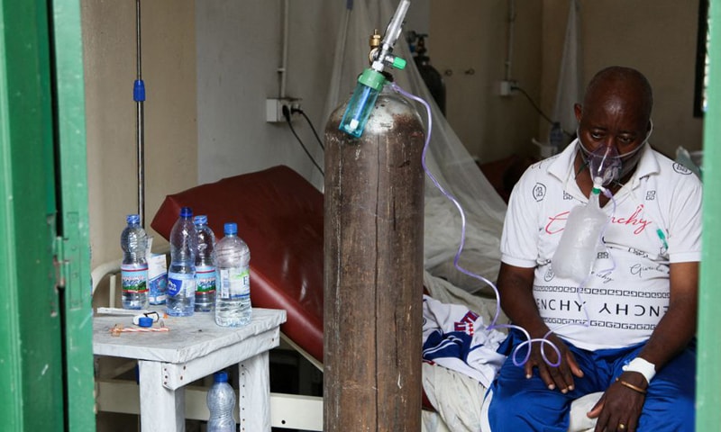 A patient breathes oxygen from an old tank at the St Joseph Covid-19 treatment centre in Kinshasa, Democratic Republic of Congo on December 24, 2021. — Reuters