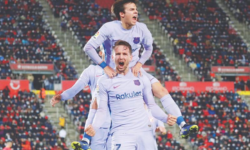 MALLORCA: Barcelona&rsquo;s Luuk de Jong (bottom) celebrates with Riqui Puig after scoring during the La Liga match against Mallorca.&mdash;Reuters