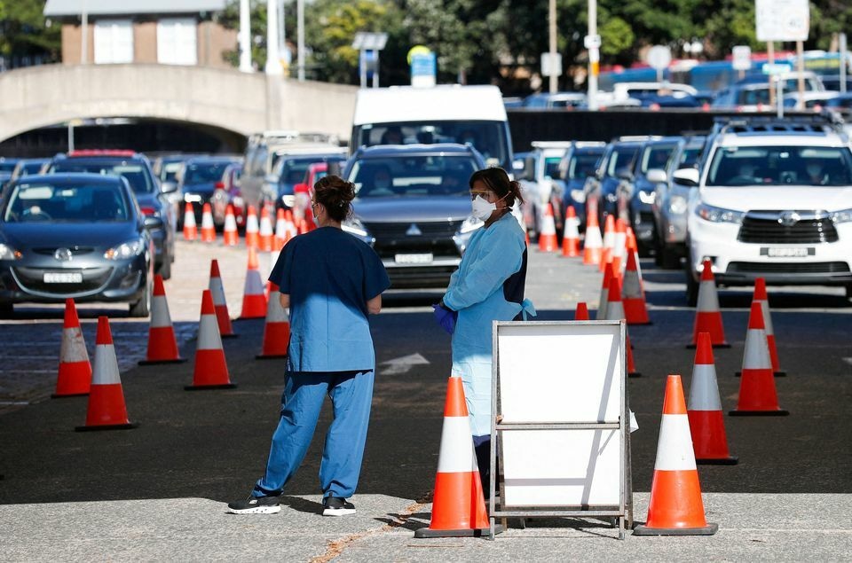 Healthcare workers wait for the next vehicle at a coronavirus testing clinic as the Omicron coronavirus variant continues to spread in Sydney, Australia, December 30. — Reuters