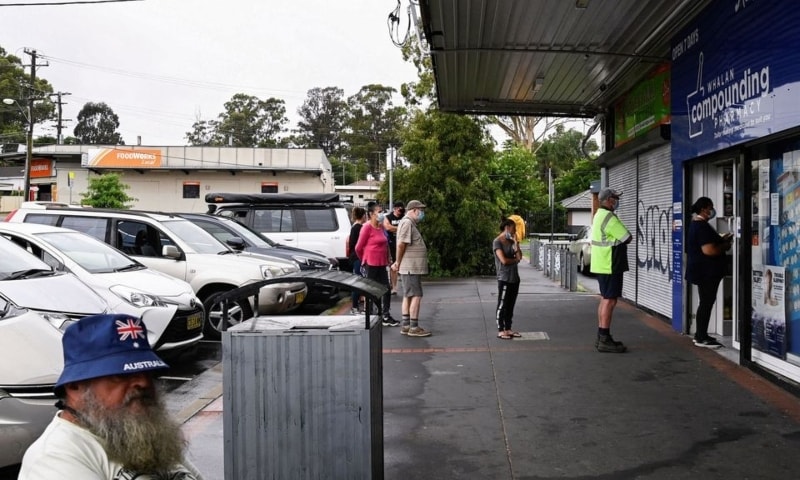 Customers queue outside a Western Sydney chemist to purchase Rapid Antigen Test kits in the wake of the coronavirus pandemic in Sydney, Australia, January 5. — Reuters