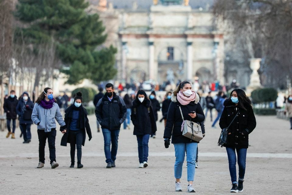 People wearing protective face masks walk in the Tuileries Gardens in Paris amid the coronavirus outbreak in France, January 5. — Reuters
