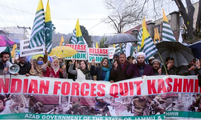 Participants of a rally under the aegis of JK Cultural Academy chant pro freedom slogans as they march through a main artery in Muzaffarabad on Wednesday to mark right to self determination day.  — Picture by author