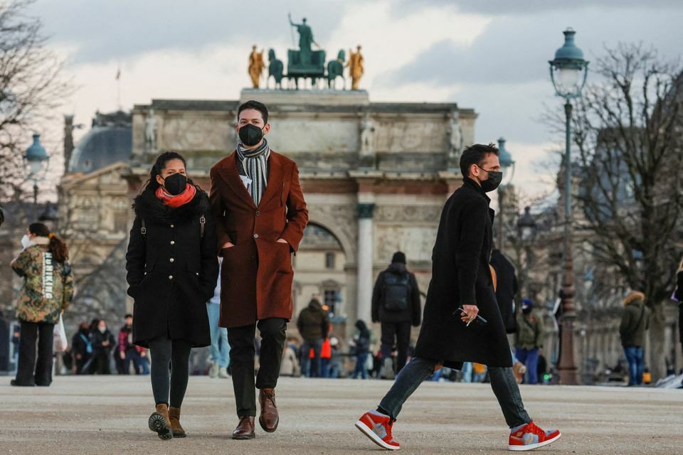People wearing protective face masks walk in the Tuileries Gardens in Paris amid the coronavirus outbreak in France, January 5. &mdash; Reuters