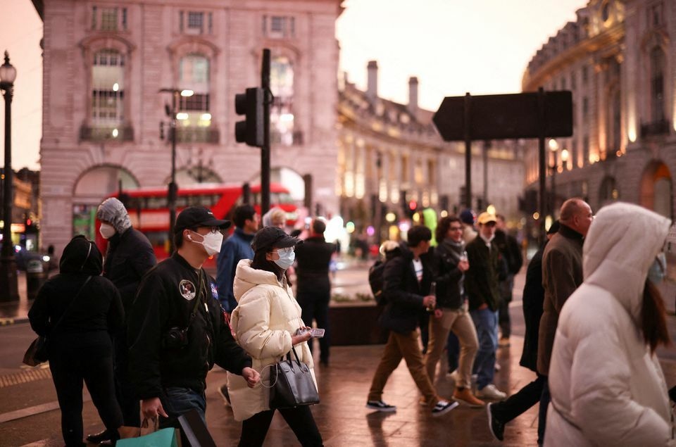People walk through Piccadilly Circus, amid the coronavirus outbreak, in central London, Britain, January 6. &mdash; Reuters