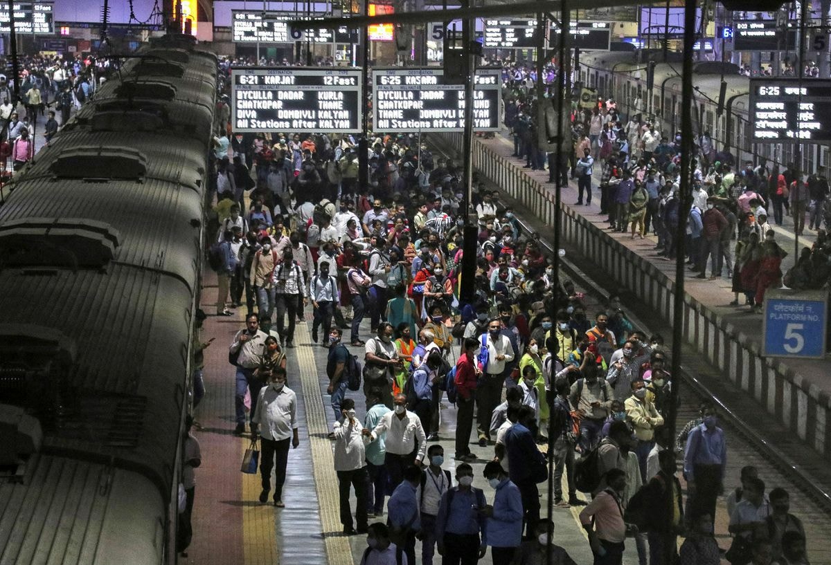 Commuters wait to board trains during evening rush hour at a railway station, amidst the spread of the coronavirus disease in Mumbai, India, January 7. — Reuters