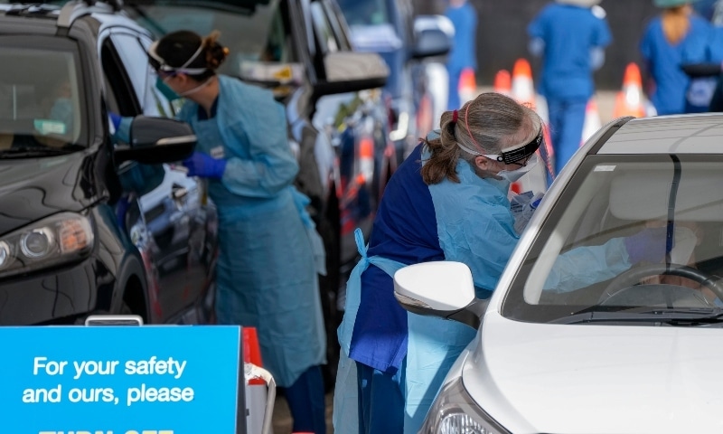 Staff collect samples at a drive-through Covid-19 testing clinic at Bondi Beach in Sydney on Jan 8. &mdash; AP