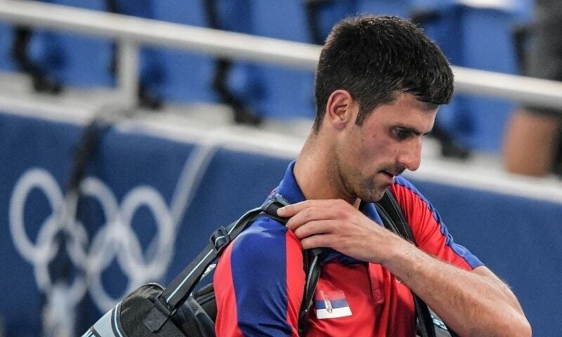 Serbia's Novak Djokovic leaves after losing to Spain's Pablo Carreno Busta the Tokyo 2020 Olympic Games men's singles tennis match for the bronze medal on July 31, 2021. — AFP/File