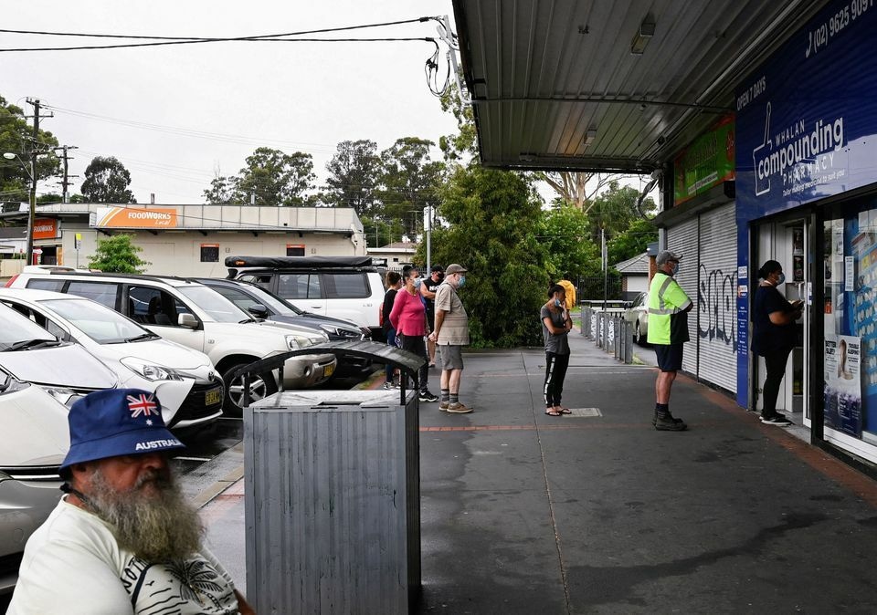 Customers queue outside a Western Sydney chemist to purchase Rapid Antigen Test kits in the wake of the coronavirus pandemic in Sydney, Australia, January 5. — Reuters