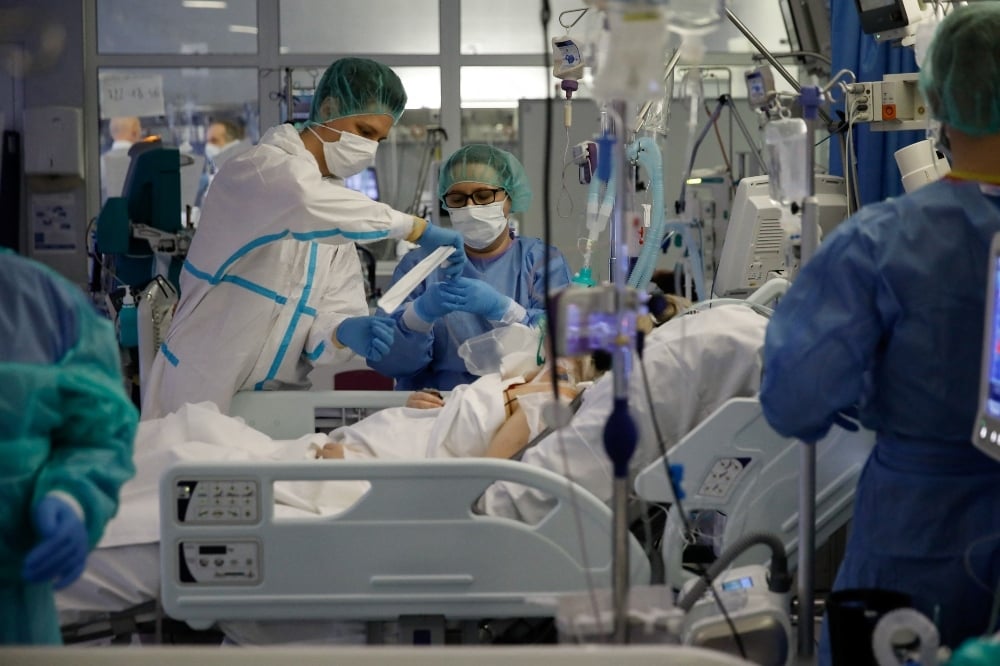 Medical staff members treat patients inside the coronavirus disease ward at the Interior Ministry Hospital in Warsaw on January 11. — Reuters