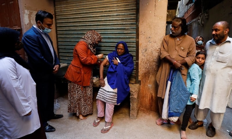 A healthcare worker administers a coronavirus vaccine during a door-to-door vaccination campaign in Karachi, January 11. — Reuters