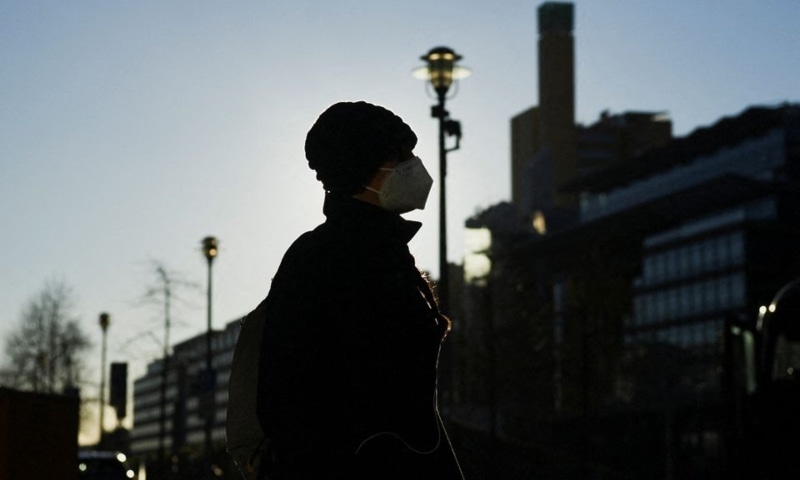 A person wearing a facemask is pictured on the public square "Potsdamer Platz" during a sunny winter day in Berlin, Germany, January 6. — Reuters