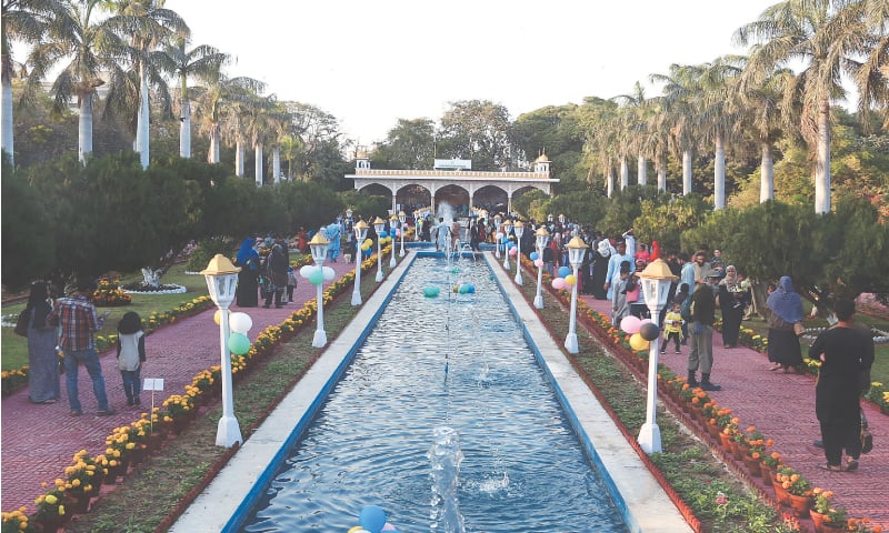 Citizens visit the Karachi Zoo Mughal Garden on Friday. They appreciated the beauty of thousands of marigolds and other seasonal flowers tastefully arranged at the picturesque point.—Shakil Adil / White Star