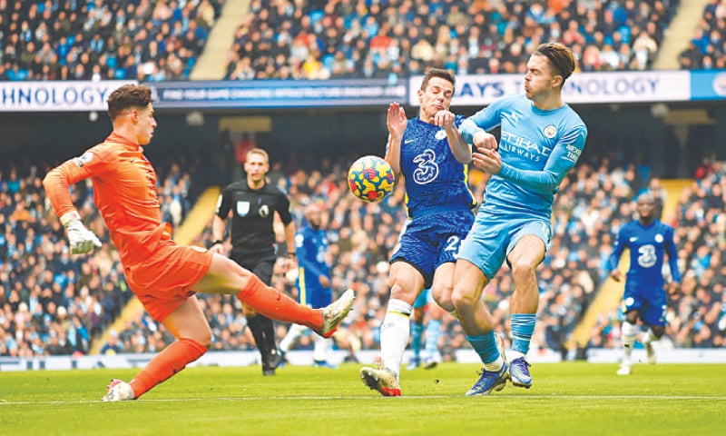 MANCHESTER: Chelsea goalkeeper Kepa Arrizabalaga attempts to clear the ball as team-mate Cesar Azpilicueta blocks Manchester City’s Jack Grealish during their Premier League match at the Etihad Stadium on Saturday.—Reuters